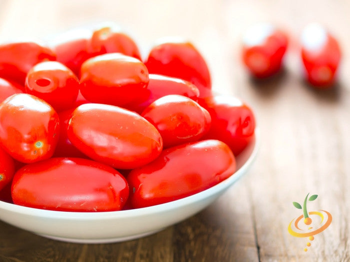Bowl of fresh red Roma tomatoes on wooden surface with logo