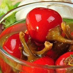 Red cherry hot pepper seeds from SeedsNow, showcasing small, vibrant red pepper seeds with fiery color.
